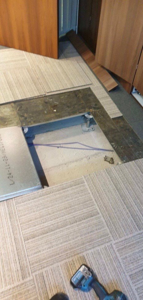 A second floor access point being fitted during a boardroom AV cabling installation