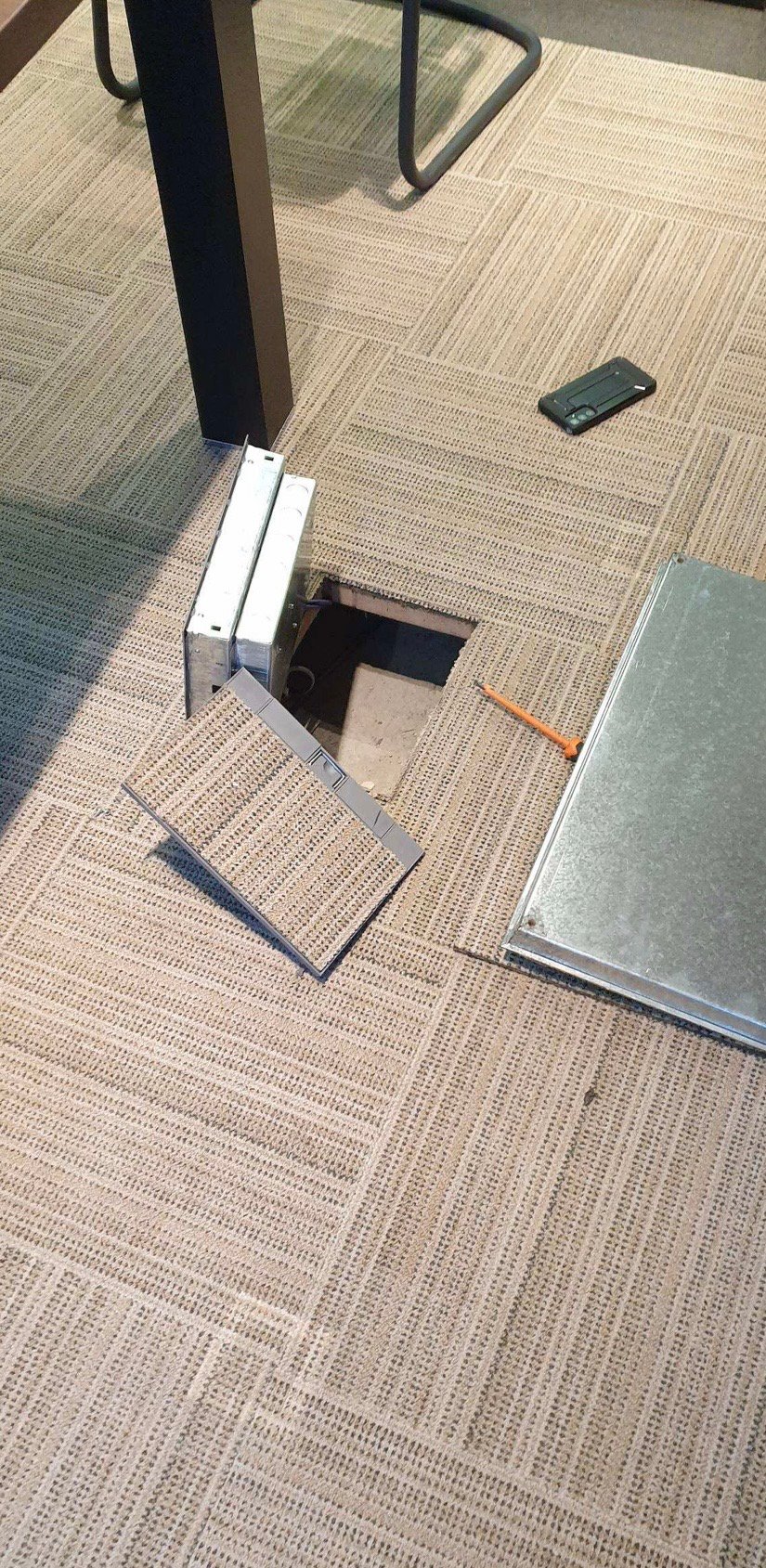 A floor pop-up connectivity box installed near the boardroom table, giving power and data without a trailing cable