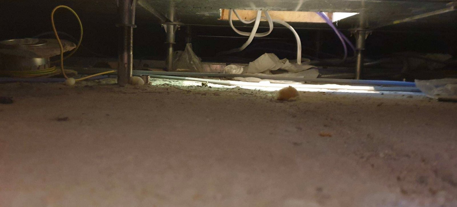 An underfloor void exposed during cabling work for a boardroom AV installation