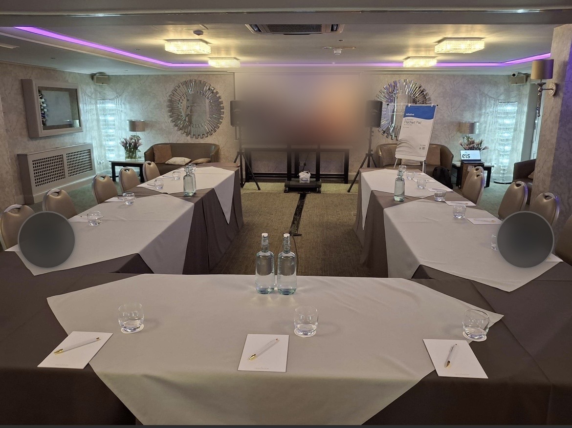 A large-format display and PA speakers set up for a corporate client event