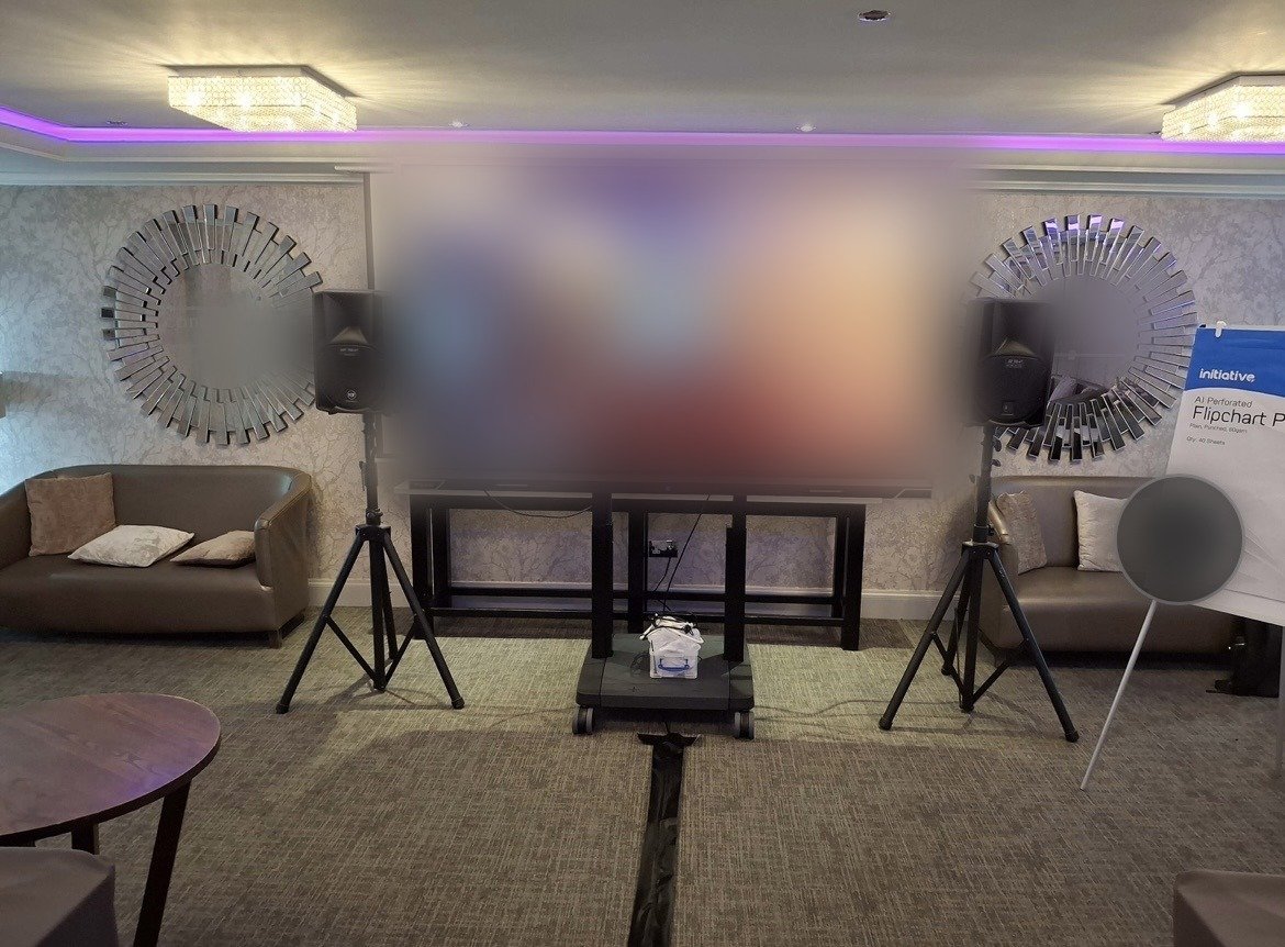 A large-format display set up in a hotel function room for a corporate client event
