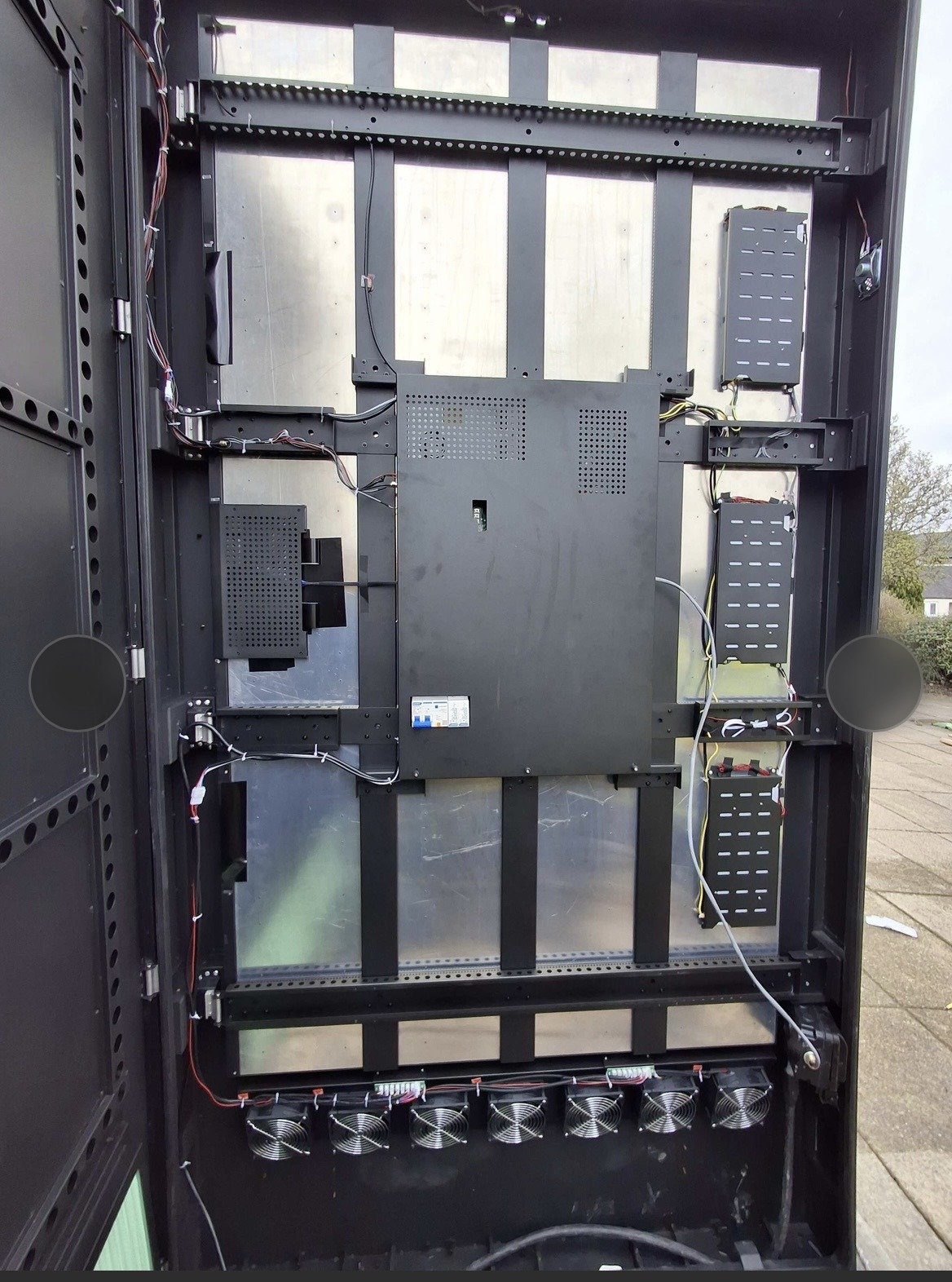 Inside the equipment cabinet of an outdoor LED screen at Lanark Memorial Hall, showing the internal wiring