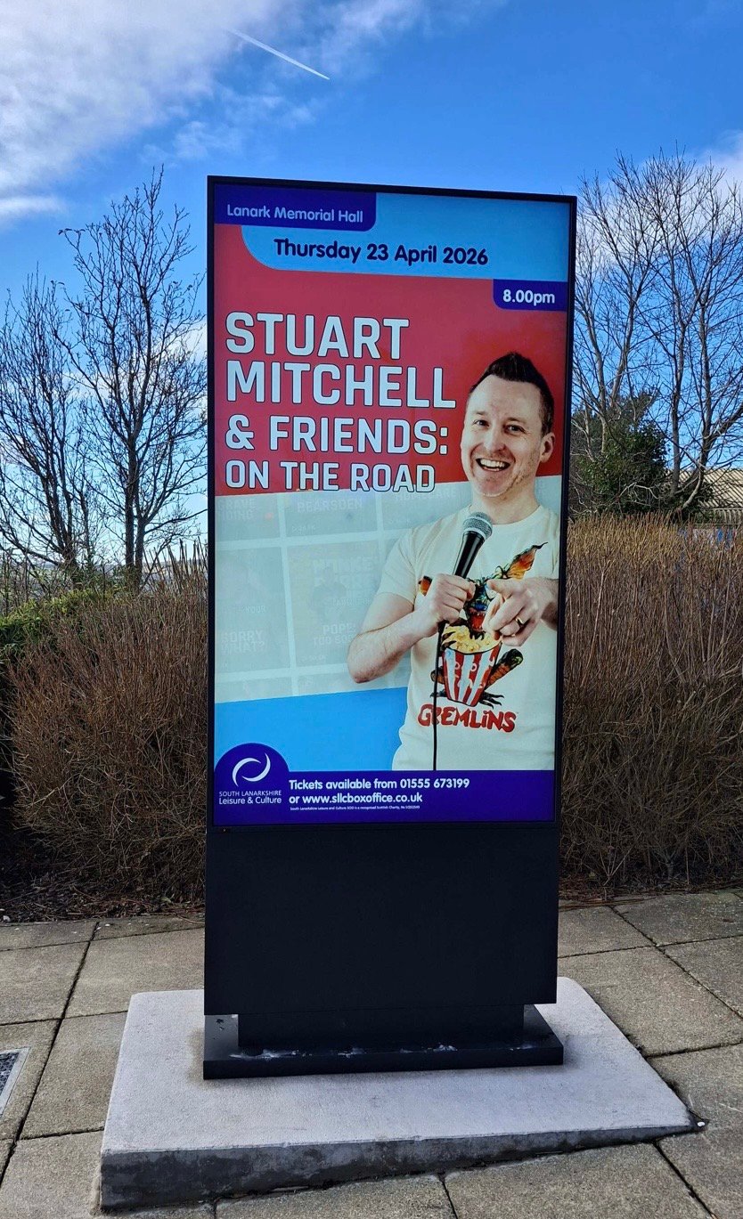 An outdoor LED screen at Lanark Memorial Hall in daylight