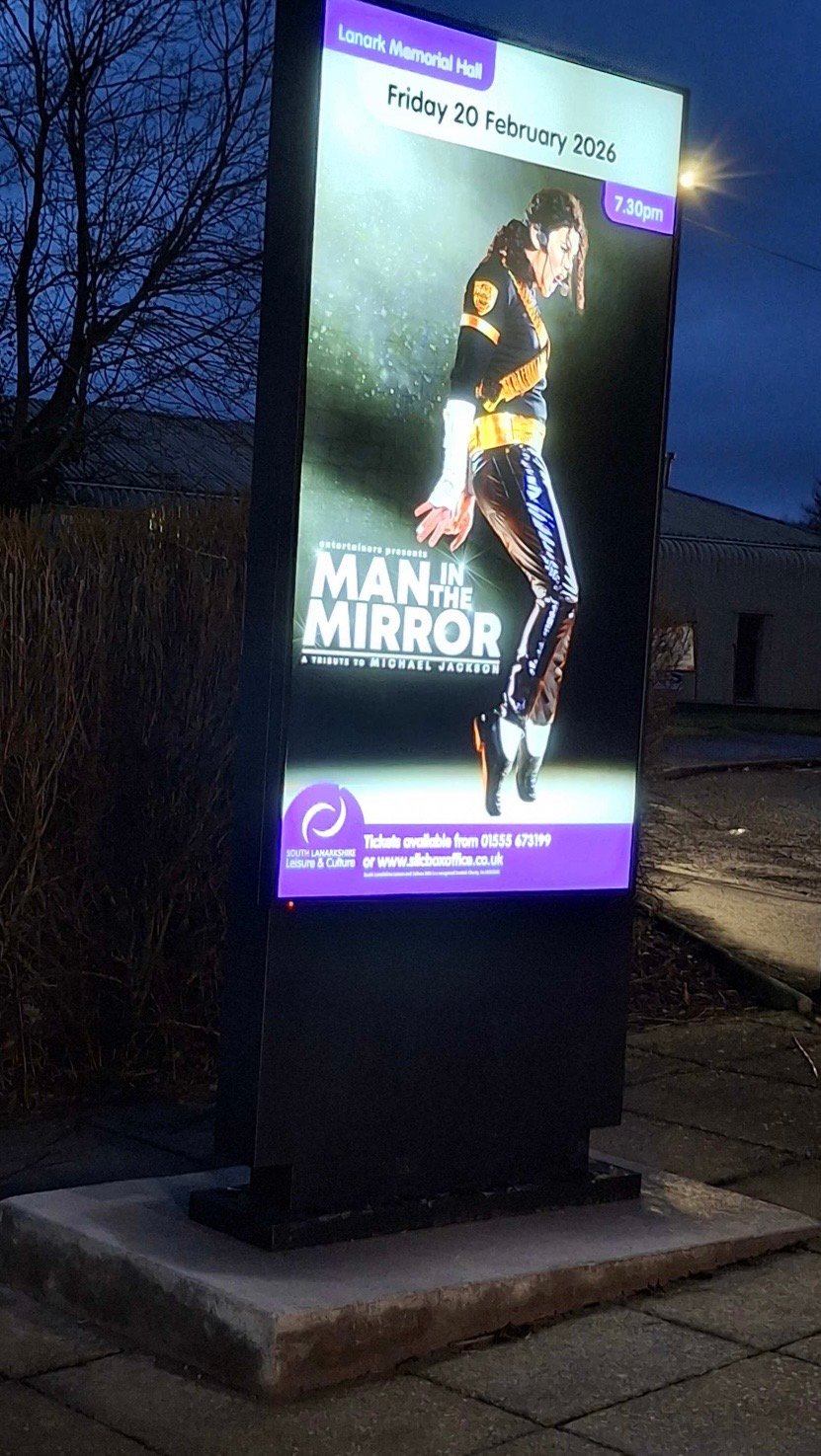 An outdoor LED screen at Lanark Memorial Hall at dusk