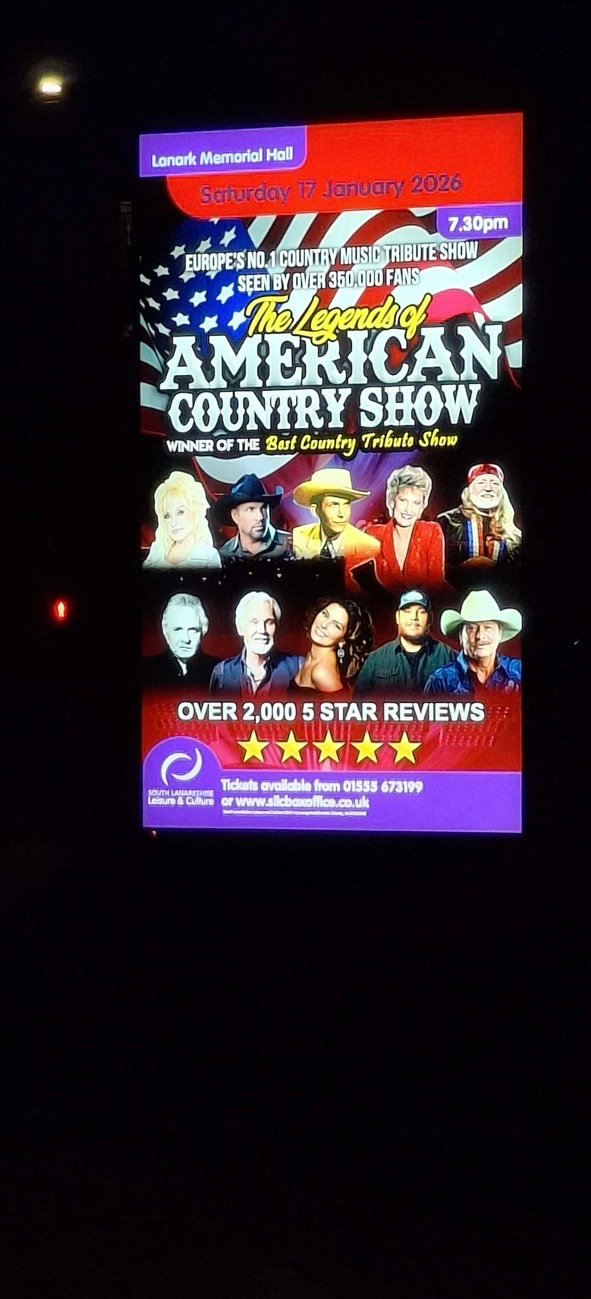 An outdoor LED screen at Lanark Memorial Hall clearly legible after dark