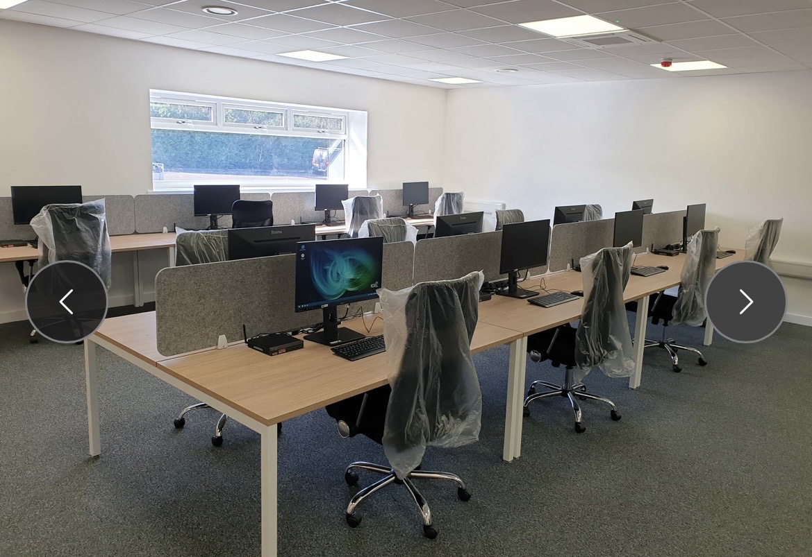 A completed office fit-out delivered by Efficient IS, showing desks, cabling and IT infrastructure in place