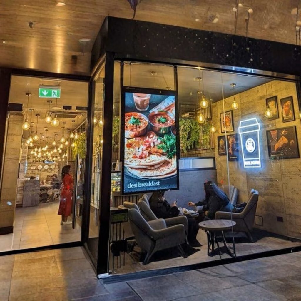 Digital window display screen showing retail promotions