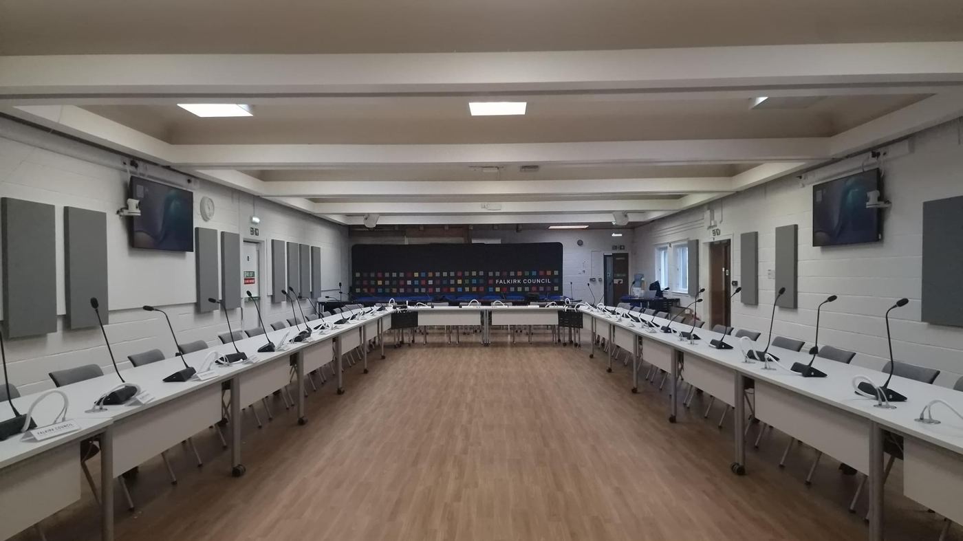 Falkirk Council Committee Chamber viewed from the opposite end, showing acoustic absorber panels along both walls and the Falkirk Council branded display screen