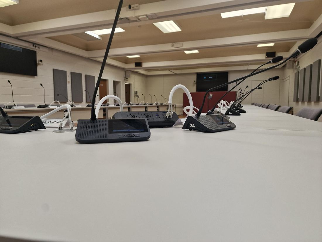 Numbered delegate positions along the Falkirk Council committee table, each with a Vissonic touchscreen unit and gooseneck microphone