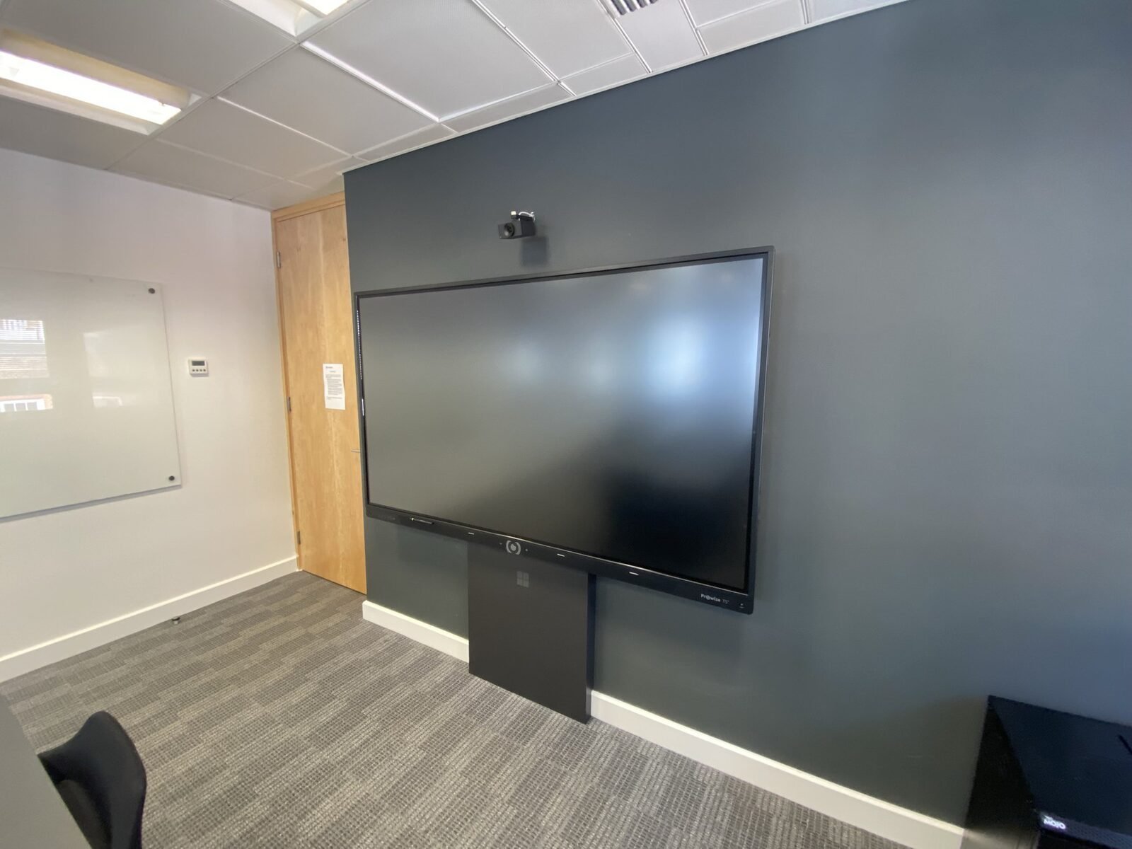 NTT DATA London boardroom - the Teams Room display wall on completion, with the room compute unit and cabling contained behind the panel